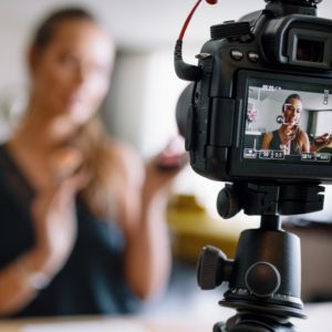 A woman is filming herself on the camera.